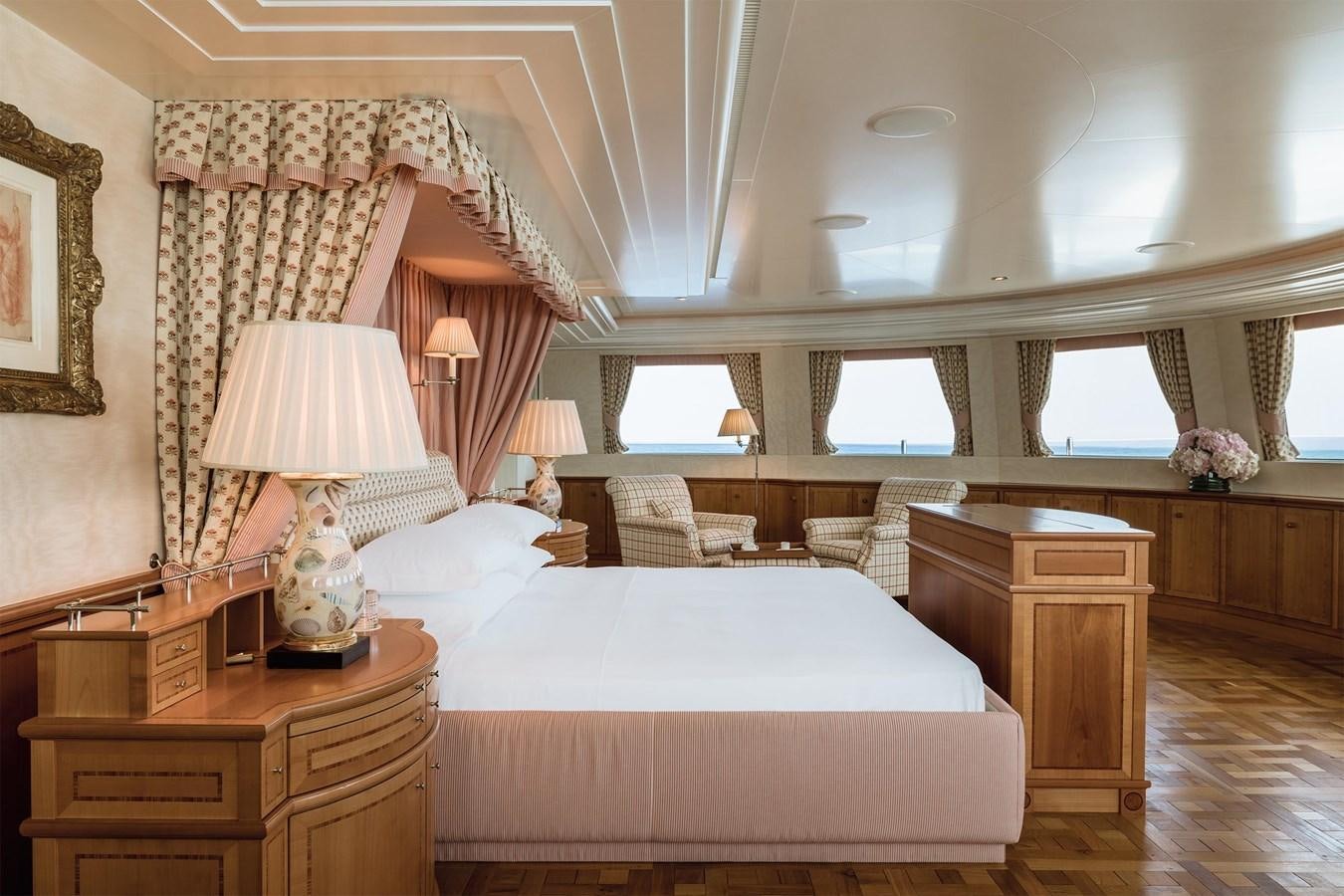 a bedroom with a bed and a desk aboard CARINTHIA VII Yacht for Sale