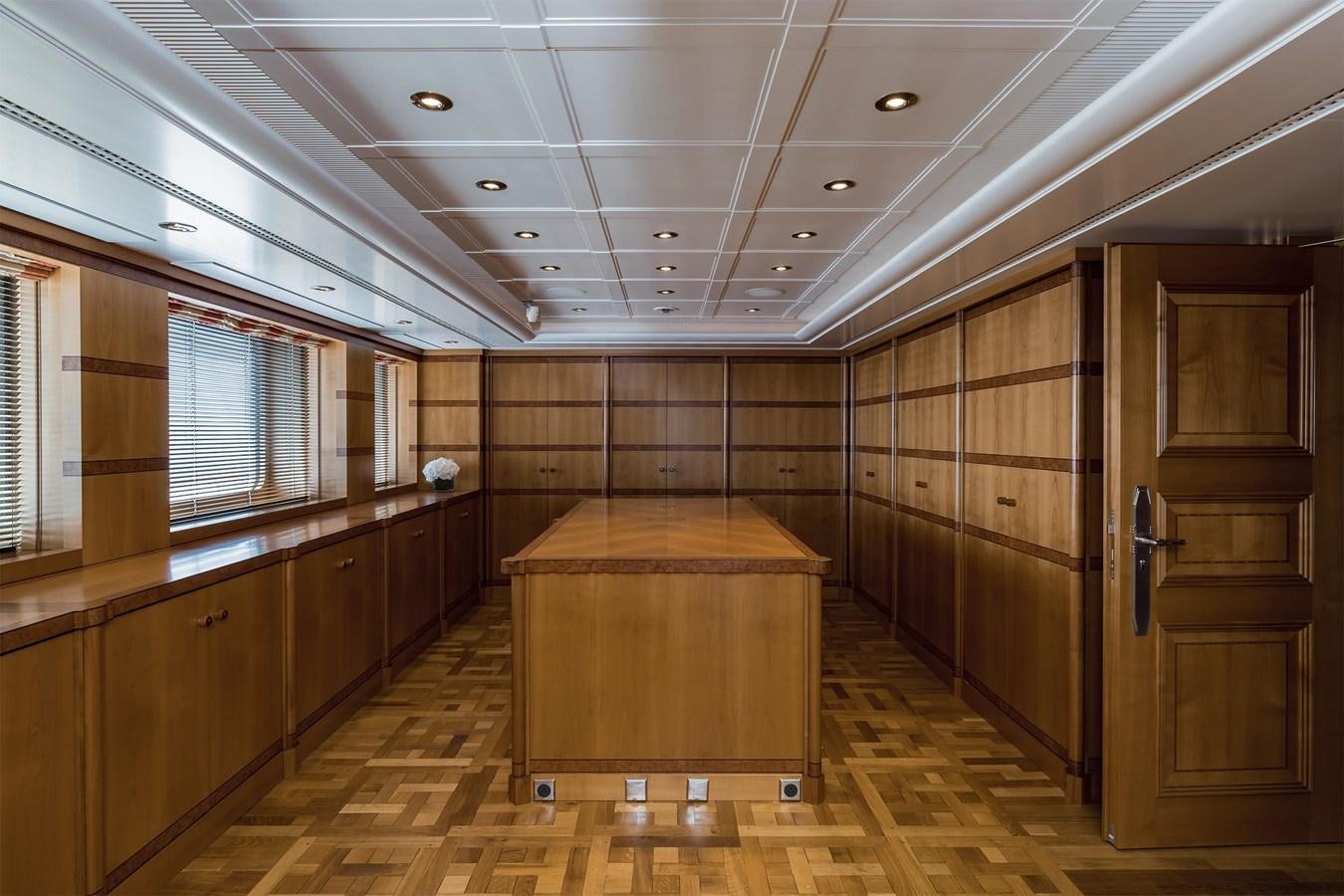 a room with wooden cabinets and a wood floor aboard CARINTHIA VII Yacht for Sale