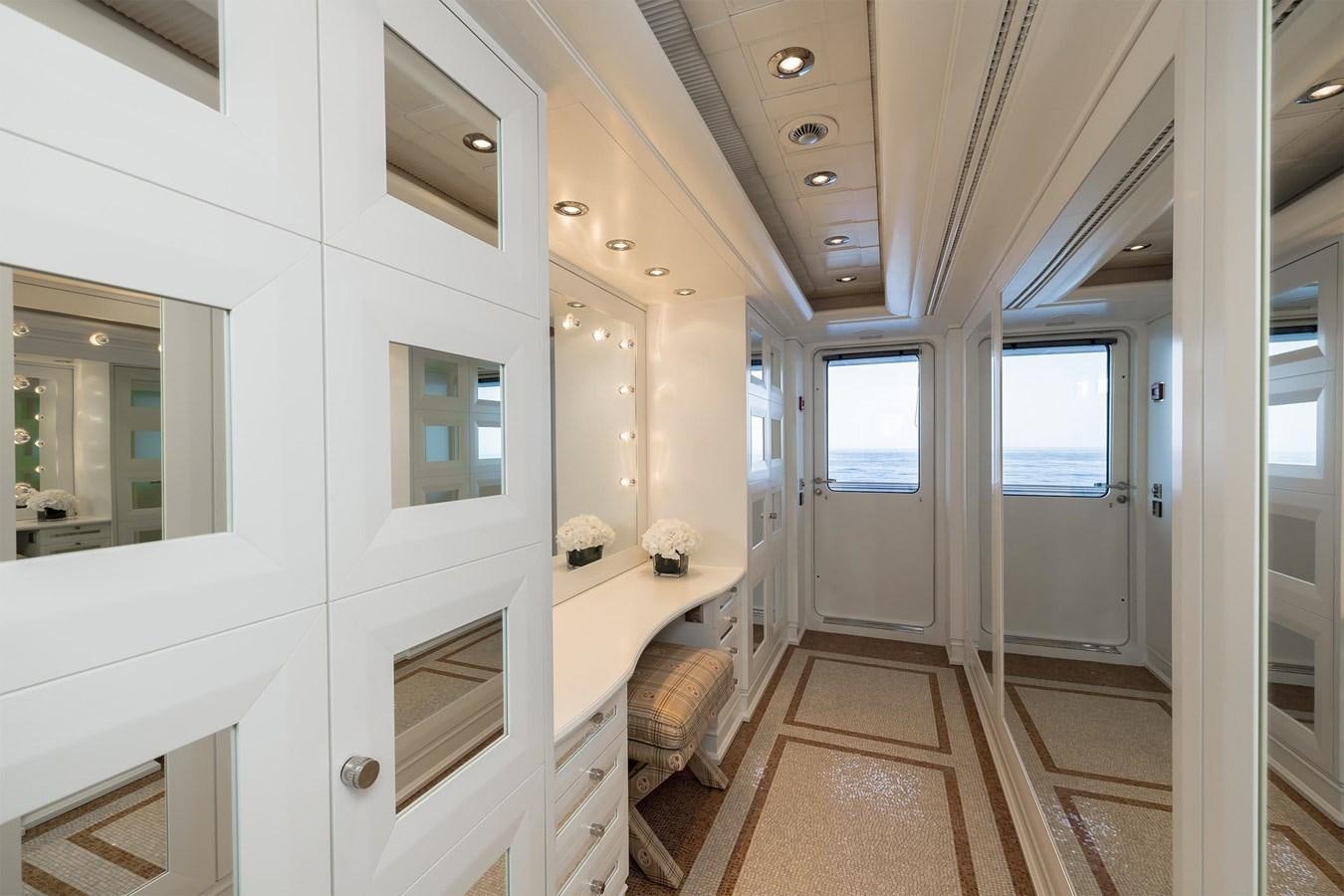 a room with a bed and a desk aboard CARINTHIA VII Yacht for Sale