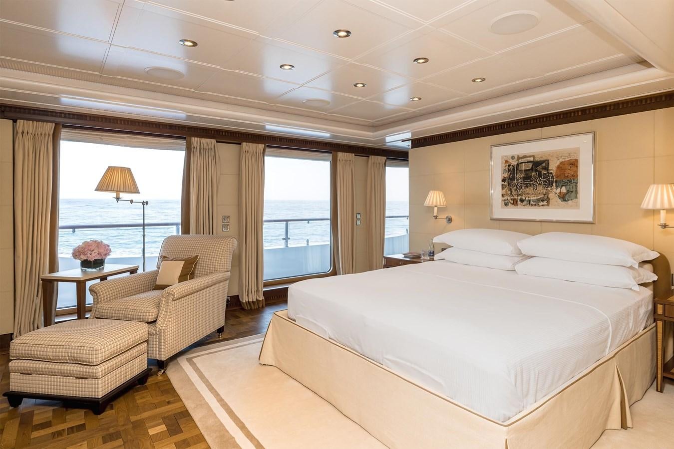 a hotel room with a bed and a chair aboard CARINTHIA VII Yacht for Sale