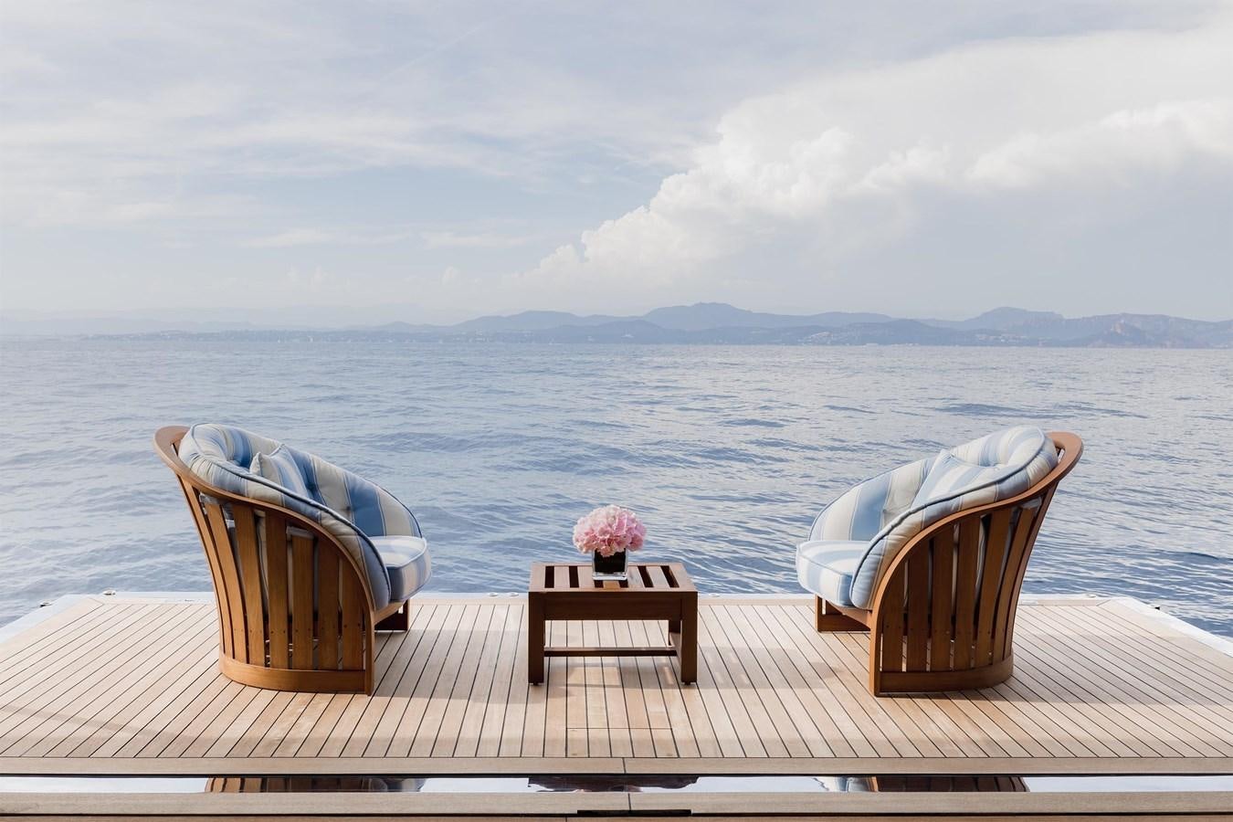 chairs on a deck overlooking a large body of water aboard CARINTHIA VII Yacht for Sale