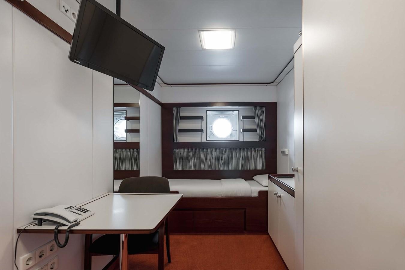 a room with a desk and a tv aboard CARINTHIA VII Yacht for Sale