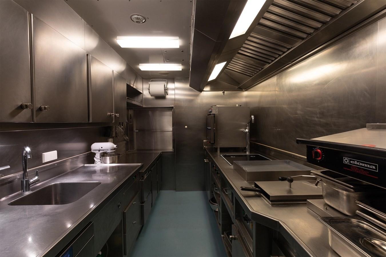 a kitchen with stainless steel appliances aboard CARINTHIA VII Yacht for Sale