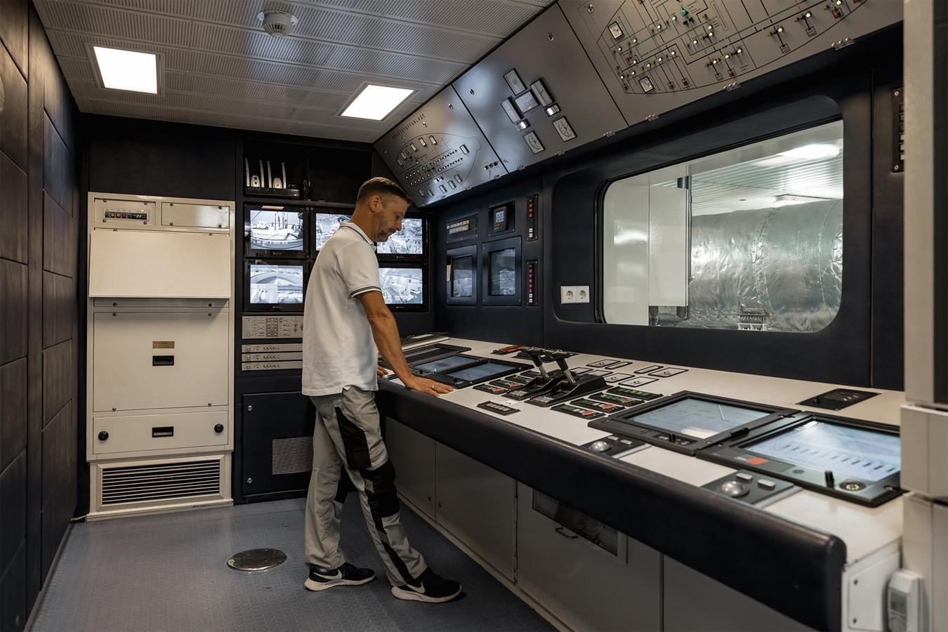 a person standing in front of a machine aboard CARINTHIA VII Yacht for Sale
