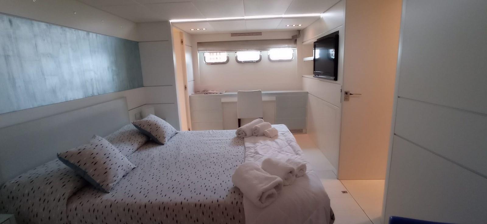 a room with a bed and a television aboard MATHISSE Yacht for Sale