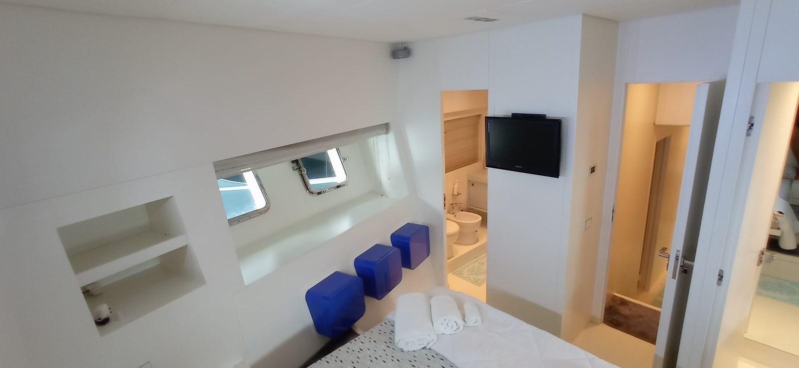 a room with a bed and a television aboard MATHISSE Yacht for Sale