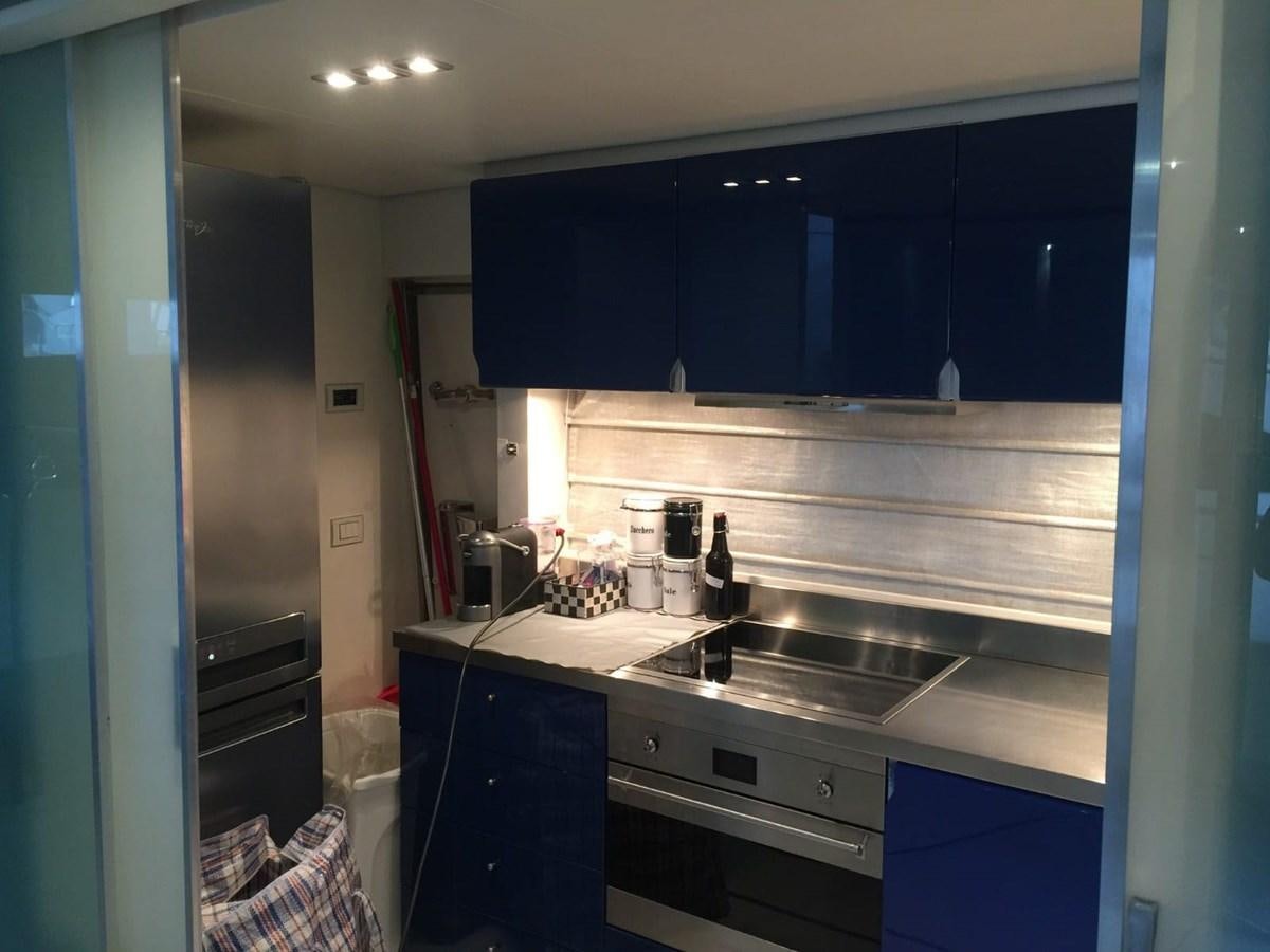 a kitchen with blue cabinets aboard MATHISSE Yacht for Sale