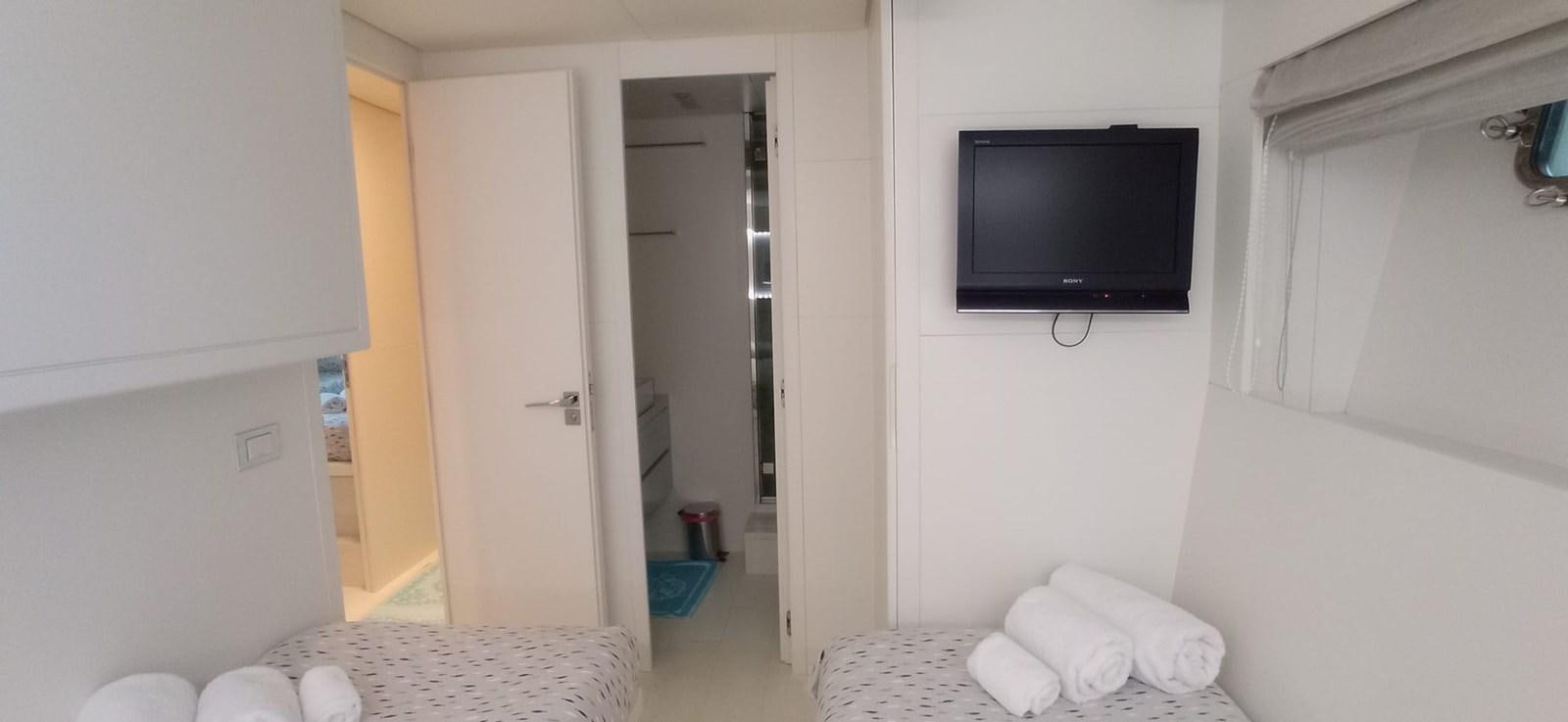 a room with a television and a bed aboard MATHISSE Yacht for Sale