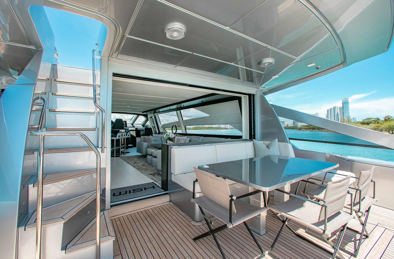 a boat with a deck and chairs aboard LADY K Yacht for Sale