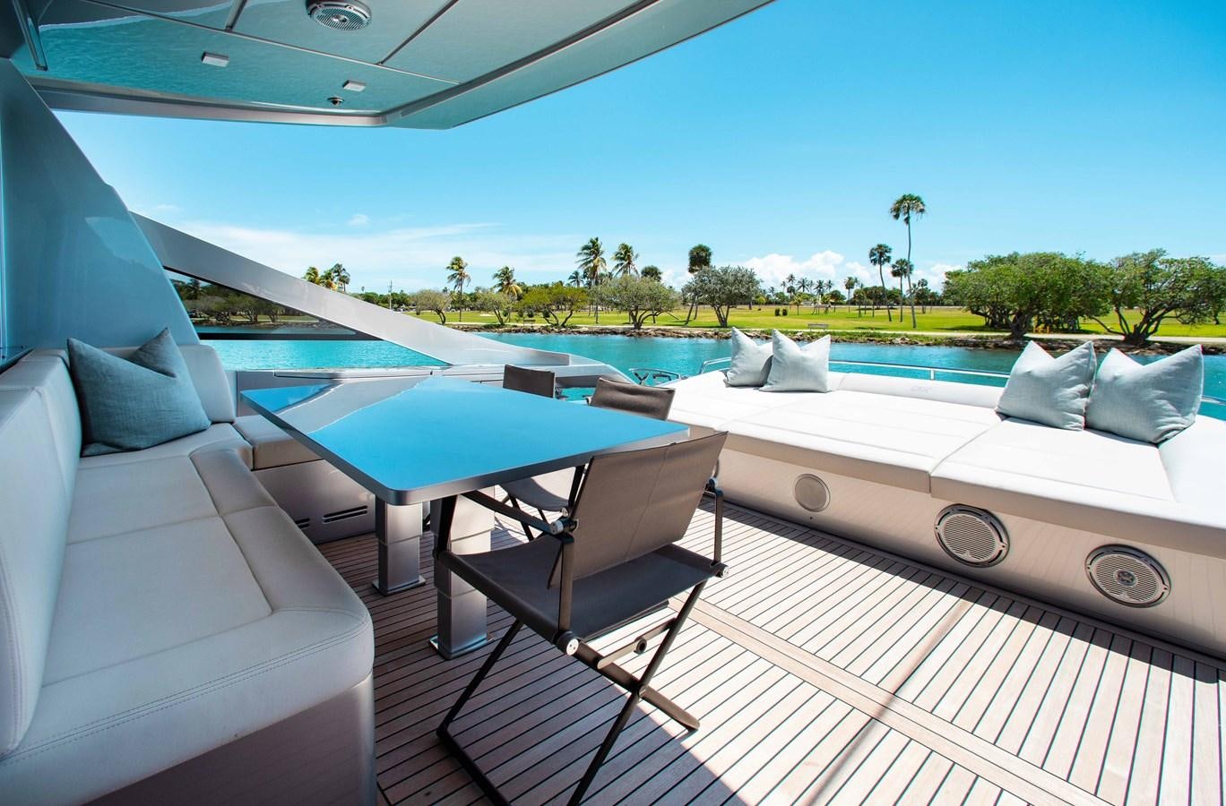 a pool with a table and chairs aboard LADY K Yacht for Sale