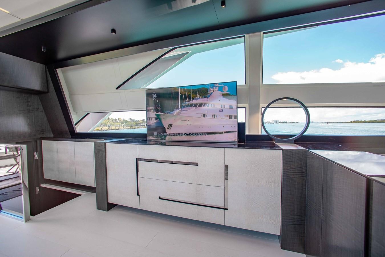 a large white room with a large window and a large screen aboard LADY K Yacht for Sale