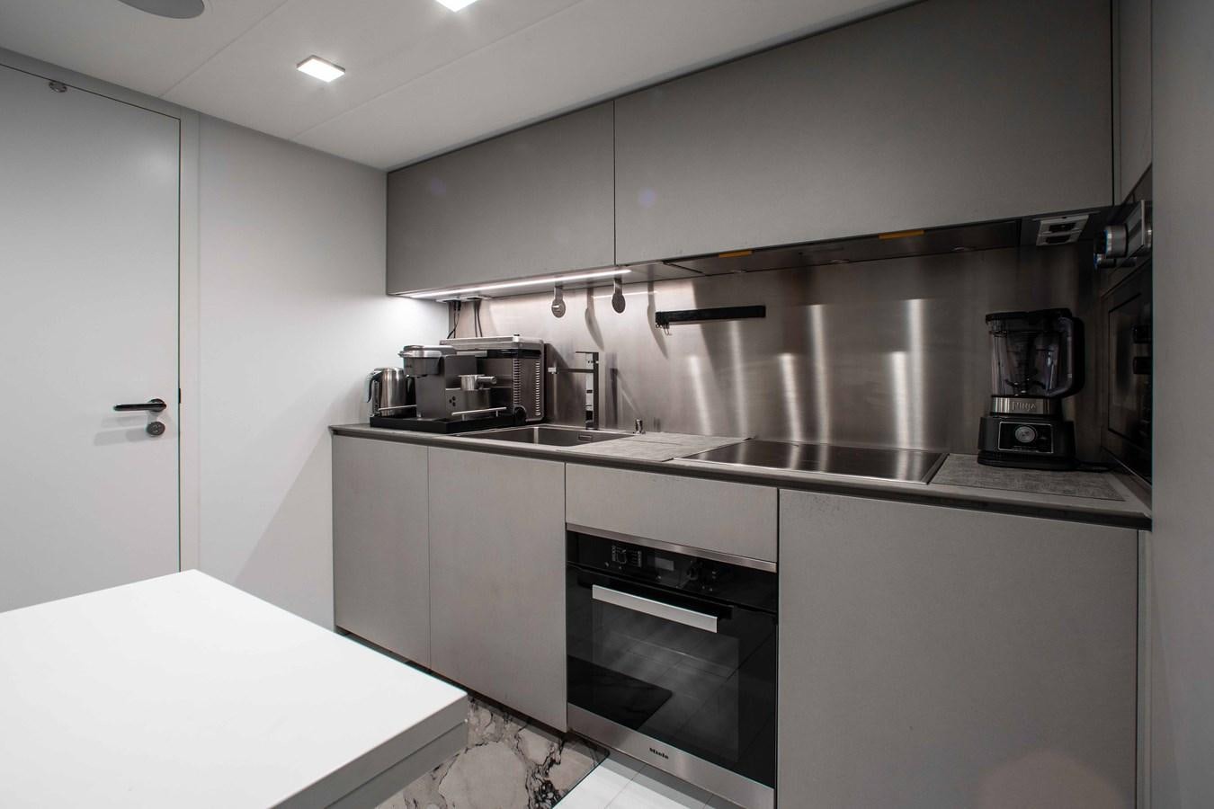 a kitchen with white cabinets aboard LADY K Yacht for Sale