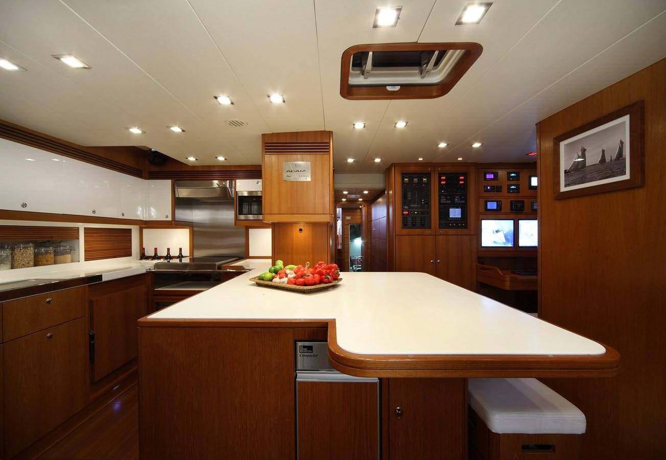 a kitchen with a table and chairs aboard ACAIA Yacht for Charter