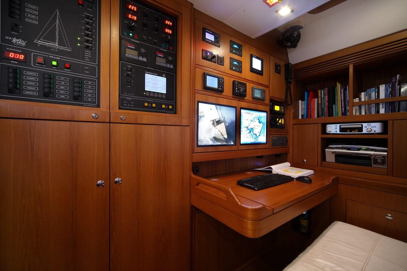 a room with a desk and computer aboard ACAIA Yacht for Charter