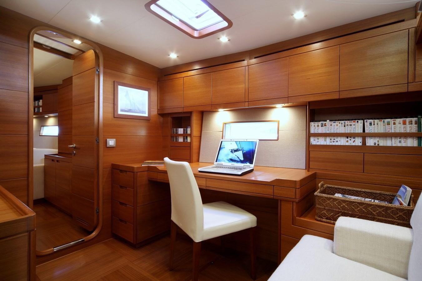 a room with a desk and a computer aboard ACAIA Yacht for Charter