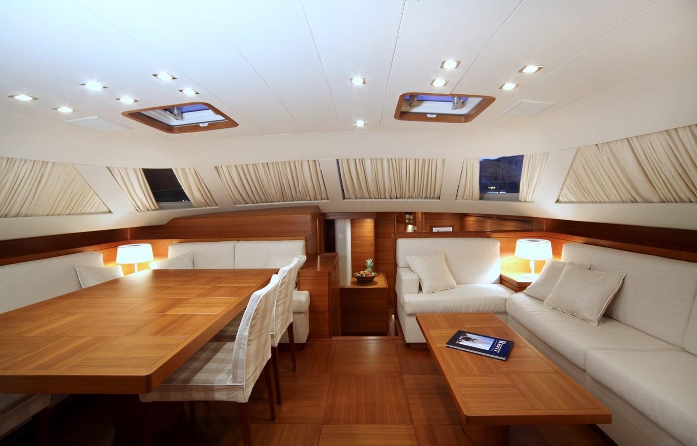 a room with a couch and a table aboard ACAIA Yacht for Charter