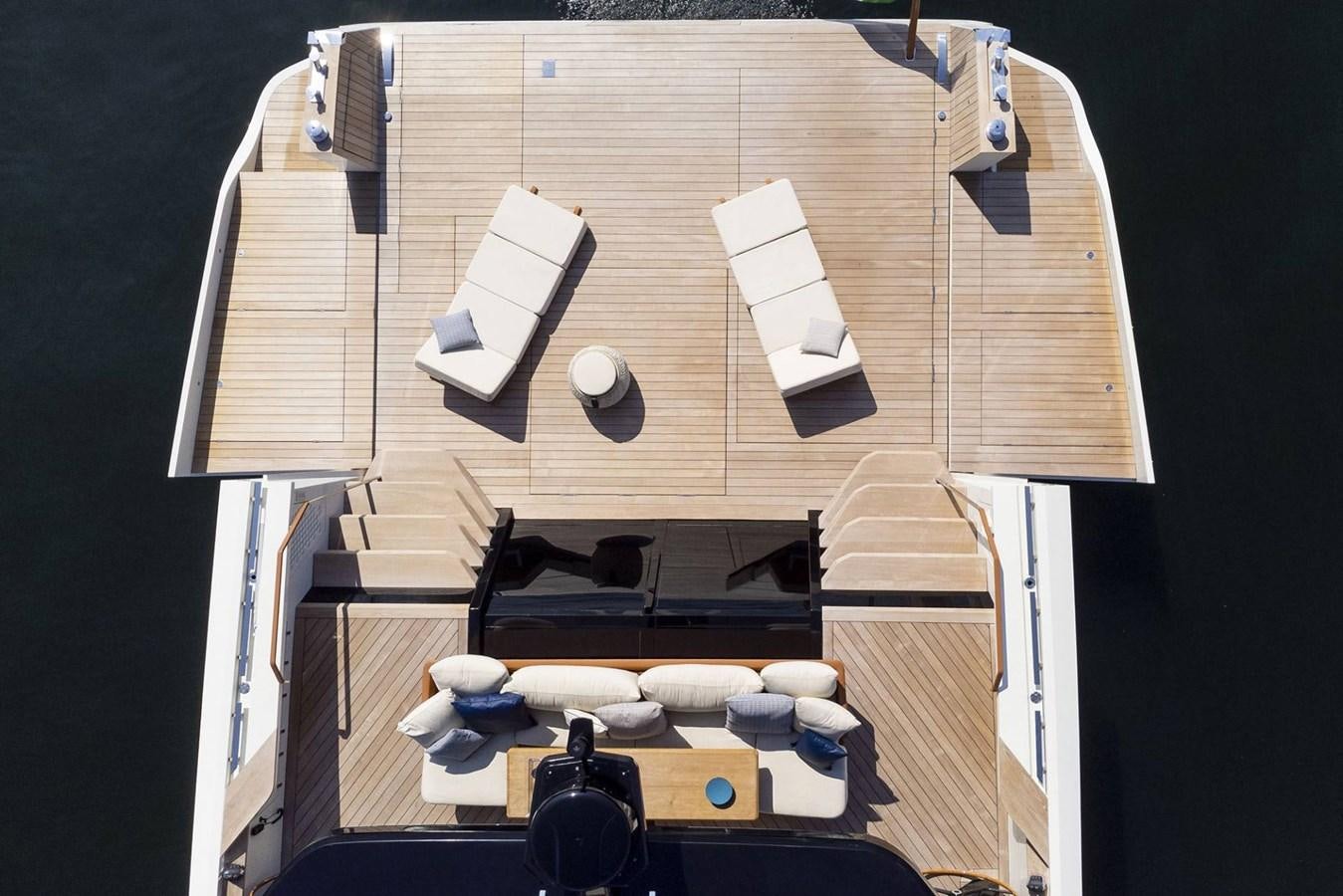 a room with a bed and a table with chairs aboard EVO V8  Yacht for Sale