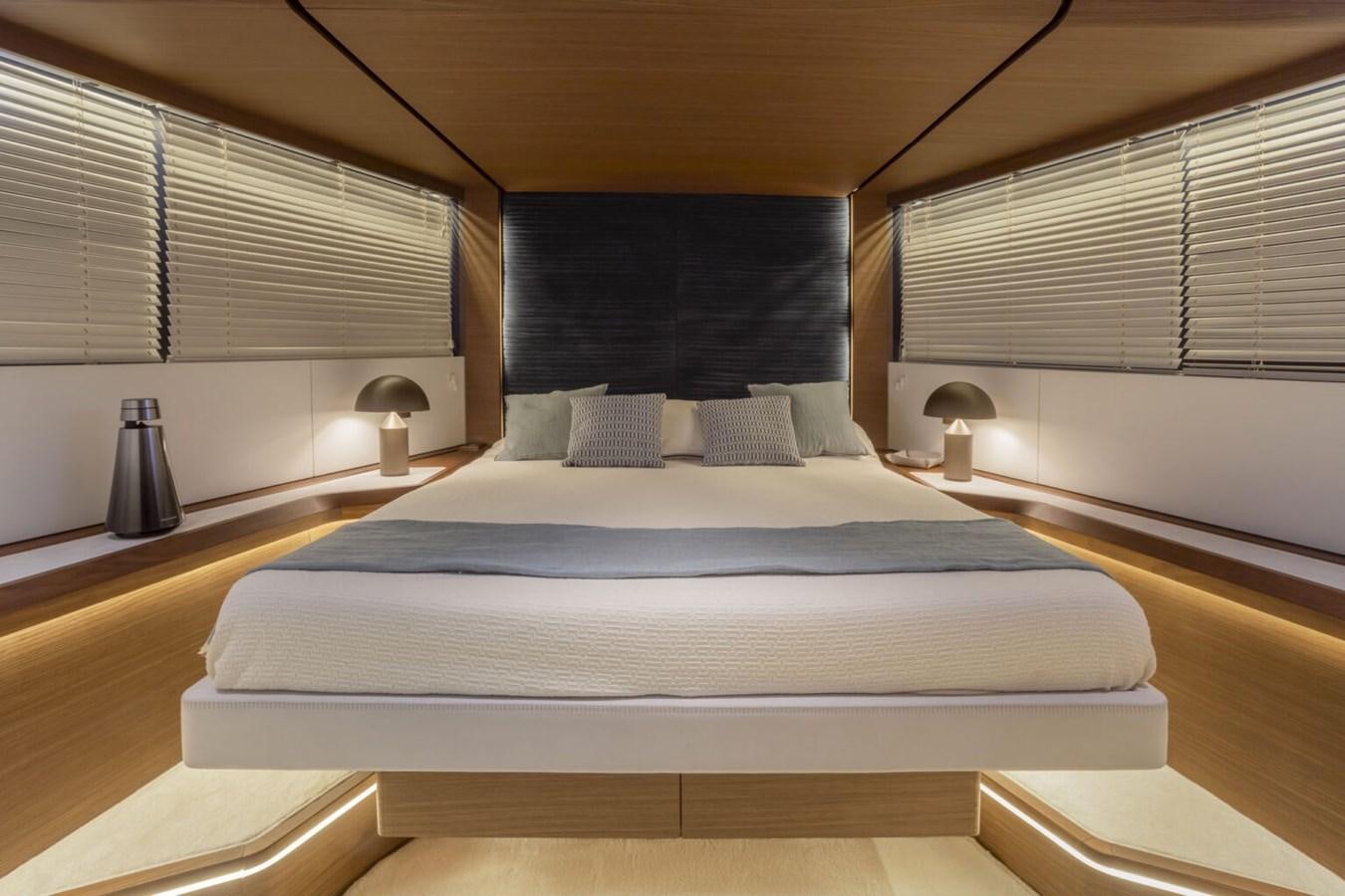 a bed with blue sheets aboard EVO V8  Yacht for Sale