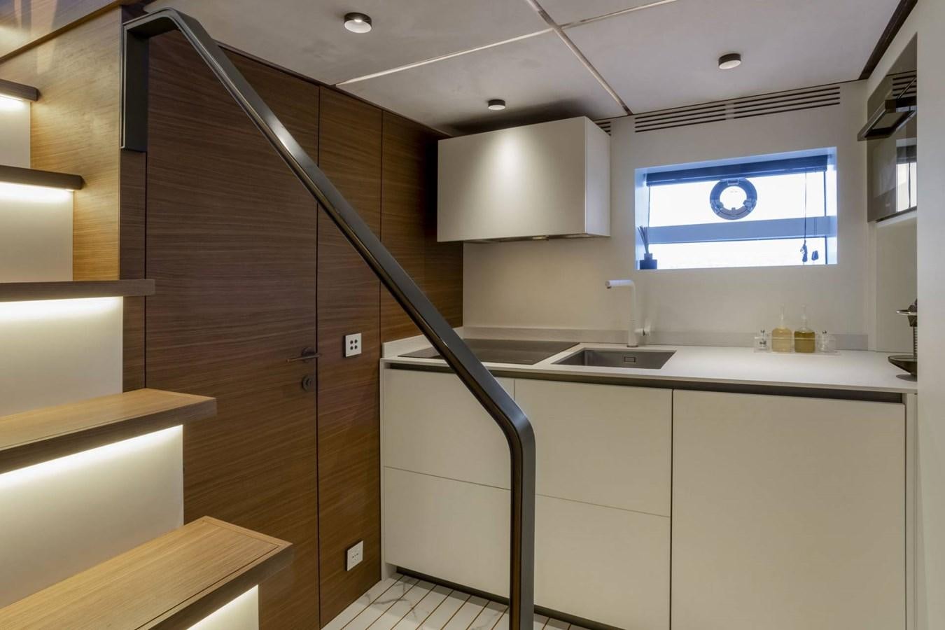 a kitchen with a wood door aboard EVO V8  Yacht for Sale