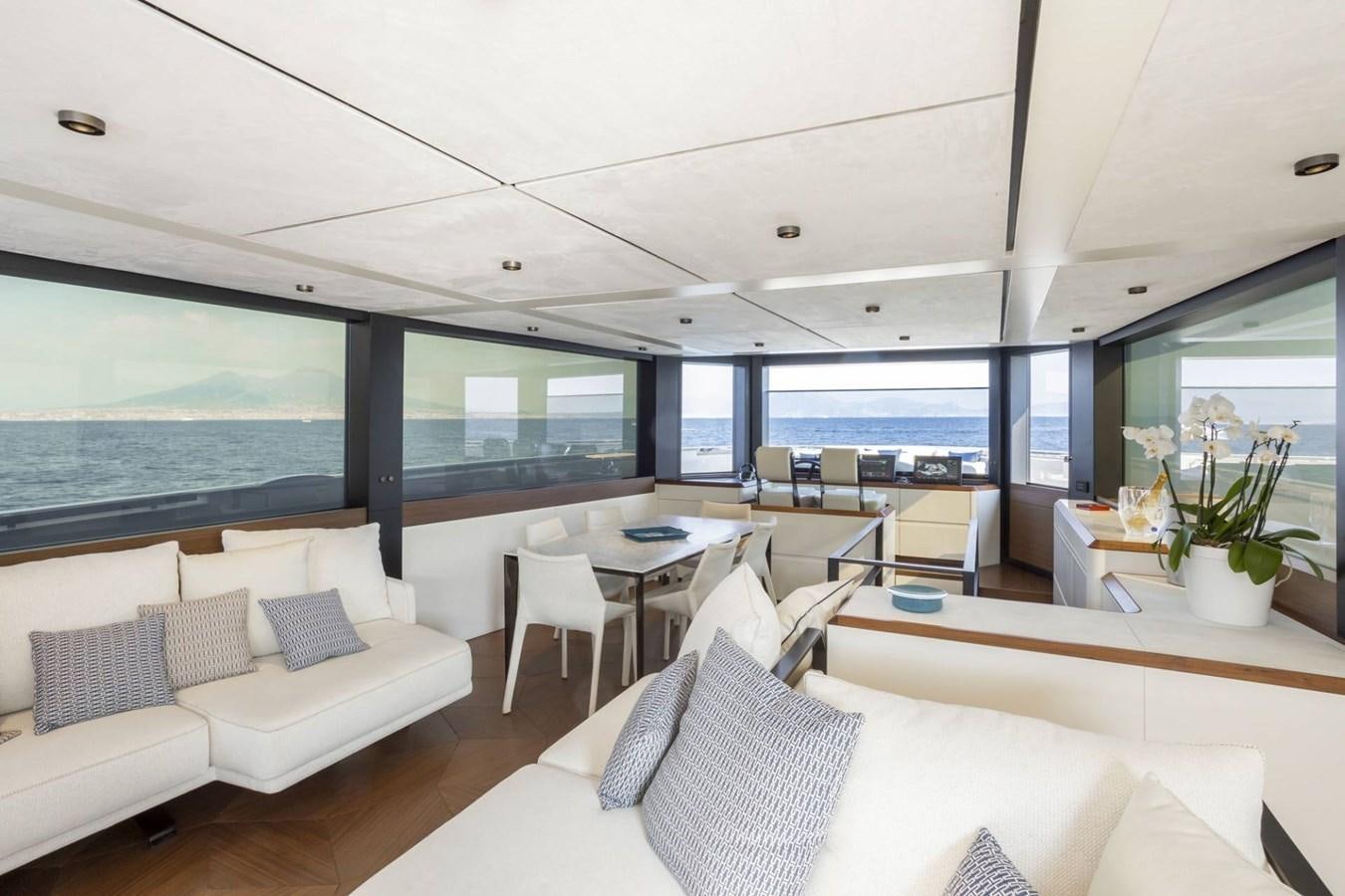 a room with a couch and a table and chairs aboard EVO V8  Yacht for Sale