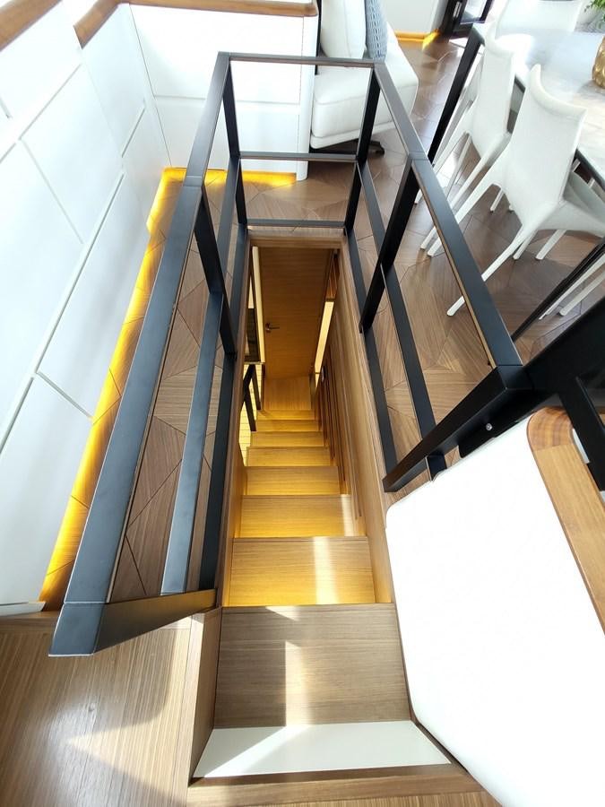 a set of stairs leading up to a room with white chairs aboard EVO V8  Yacht for Sale