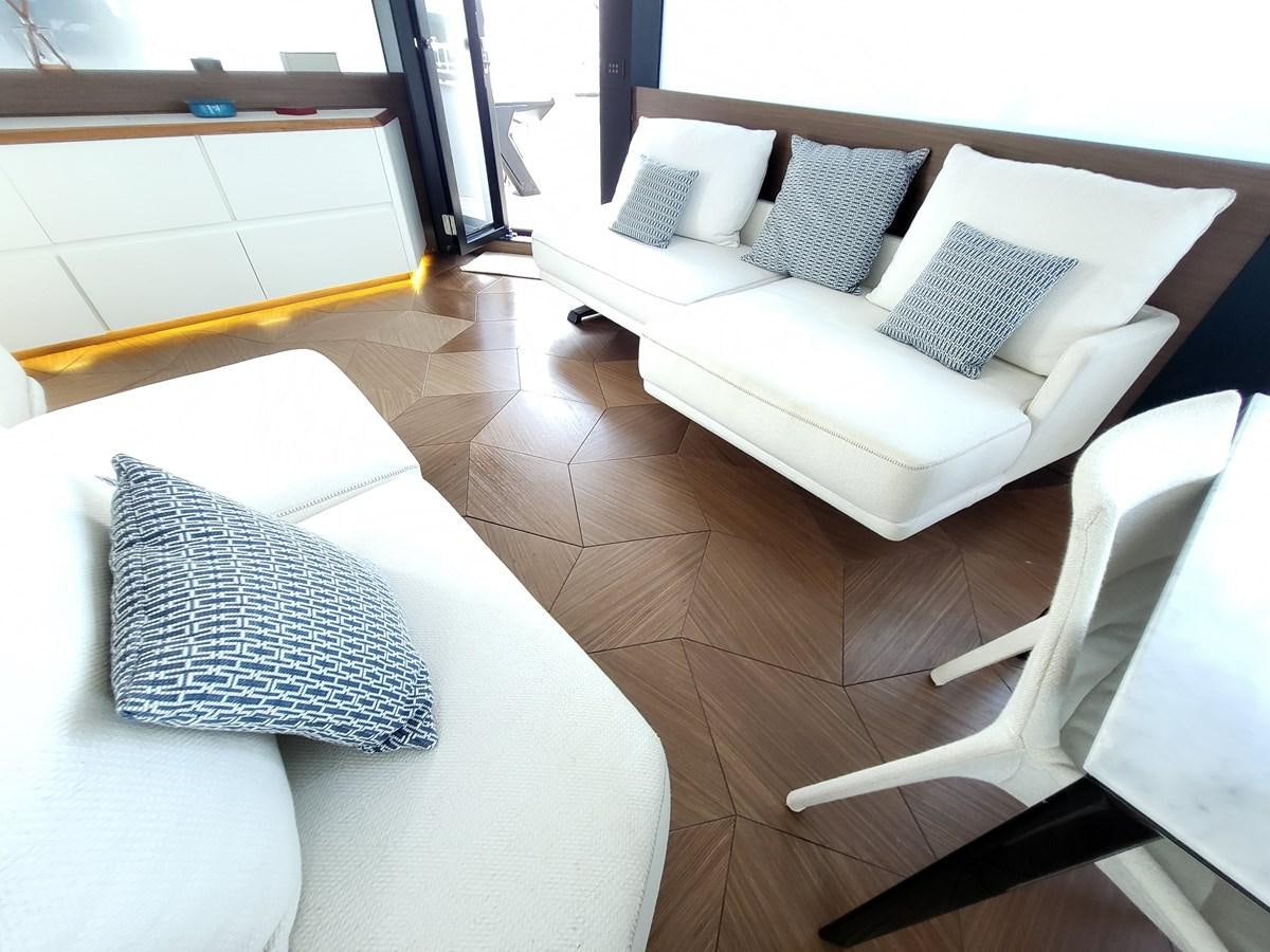 a room with couches and a chair aboard EVO V8  Yacht for Sale