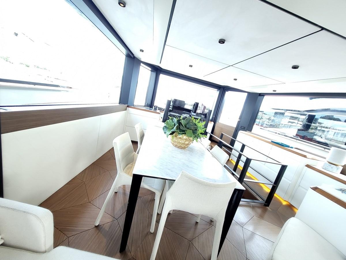 a dining room with a table and chairs aboard EVO V8  Yacht for Sale