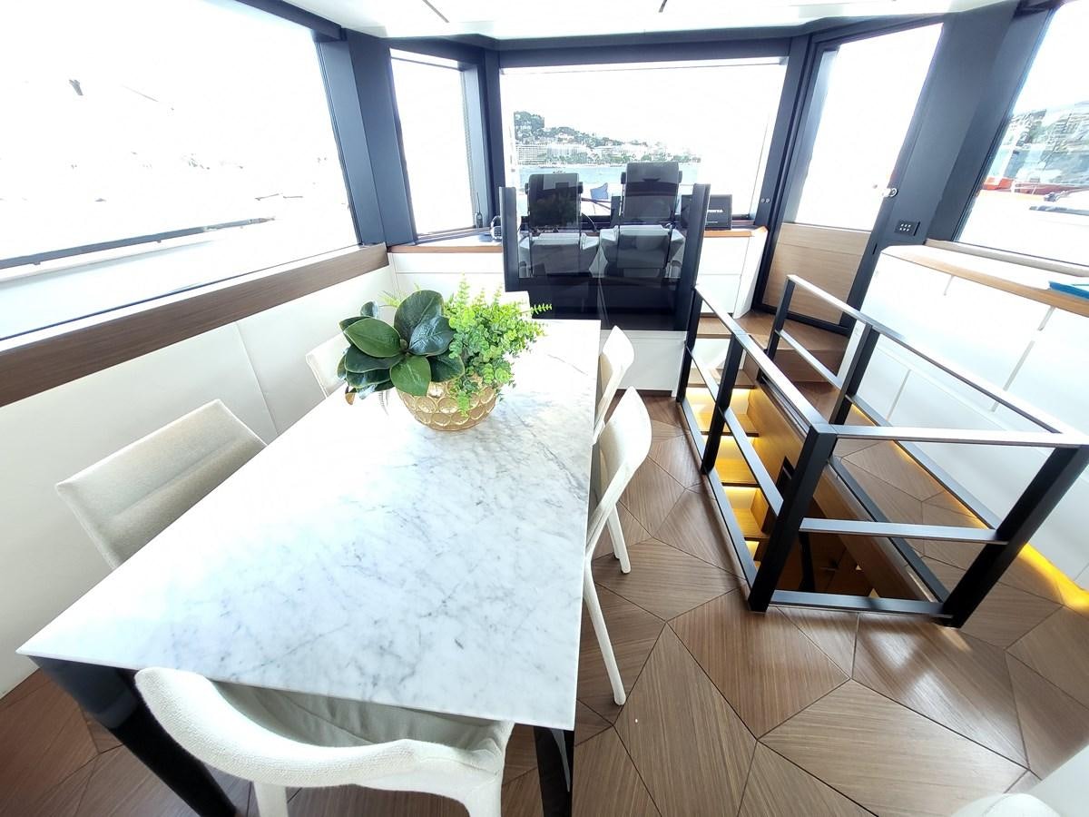 a table with chairs and plants on it aboard EVO V8  Yacht for Sale