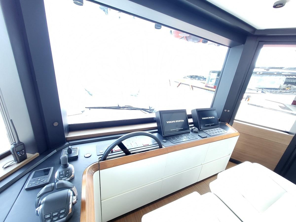 a desk with a laptop and a monitor on it aboard EVO V8  Yacht for Sale