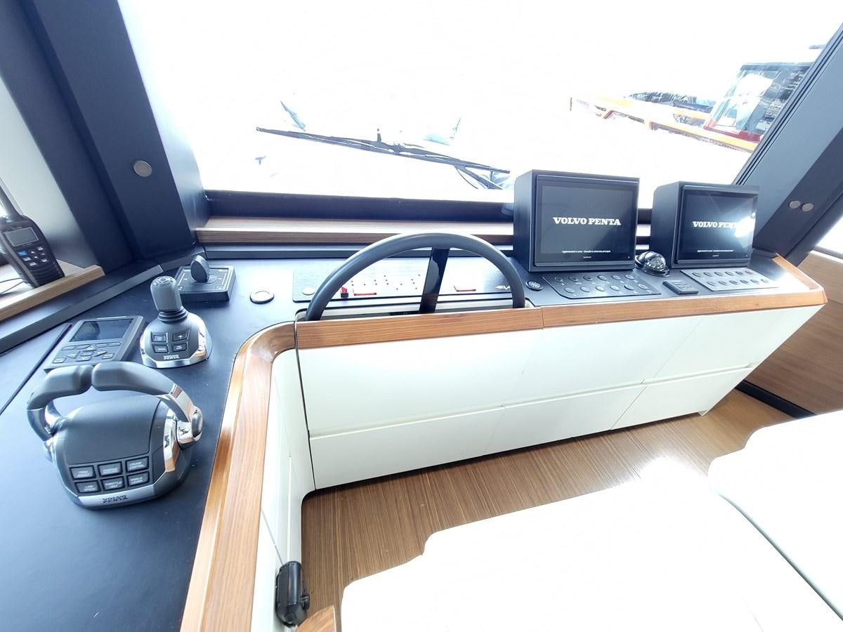 a desk with a computer and other electronics on it aboard EVO V8  Yacht for Sale