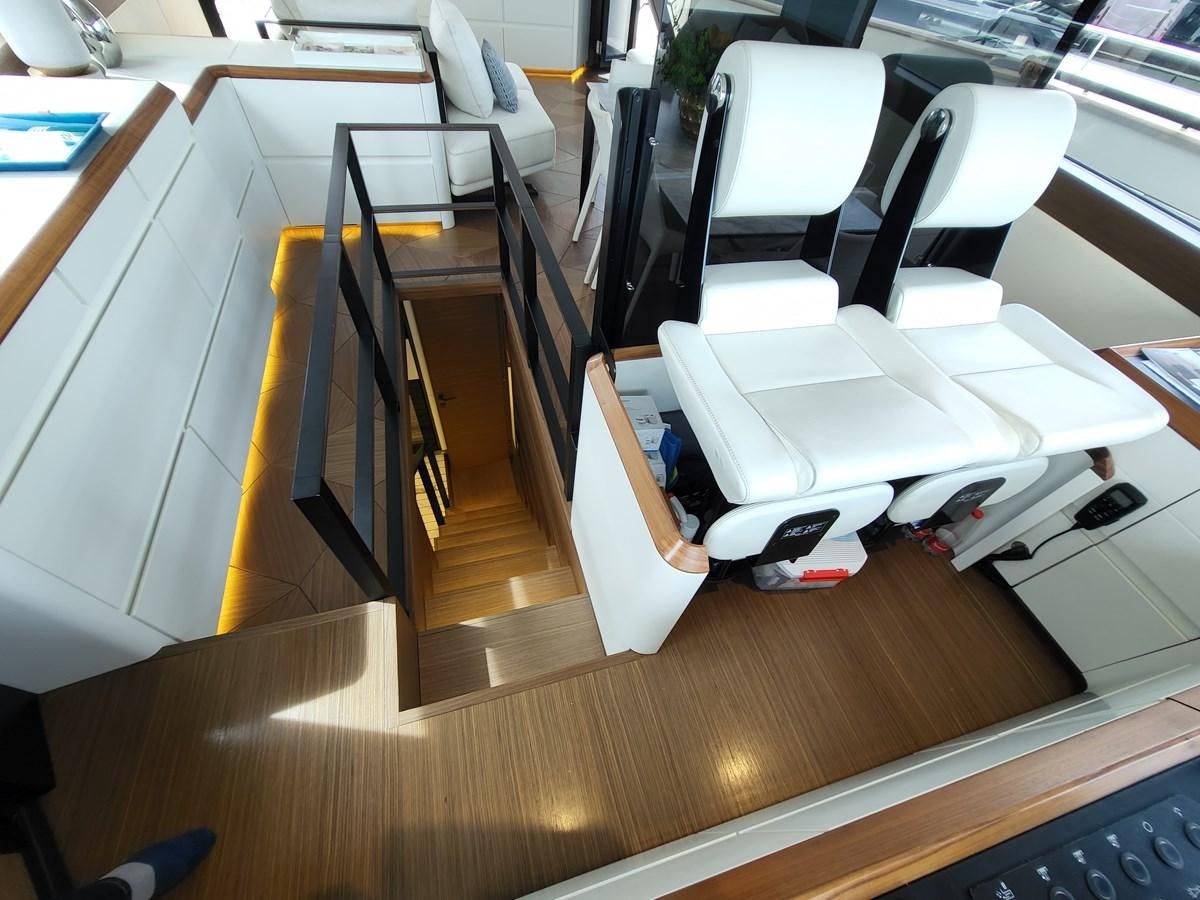 a room with a desk and chairs aboard EVO V8  Yacht for Sale