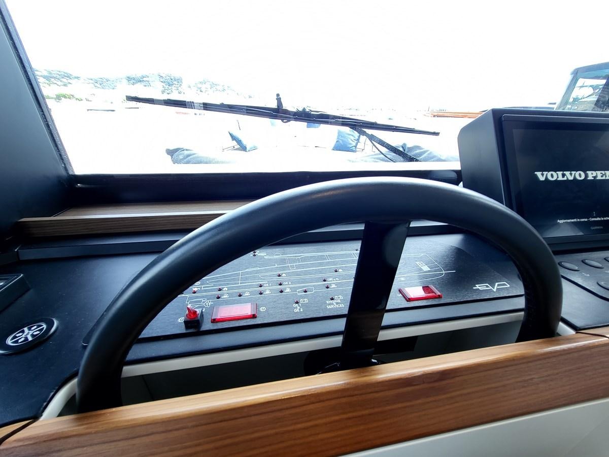 a steering wheel and dashboard of a car aboard EVO V8  Yacht for Sale
