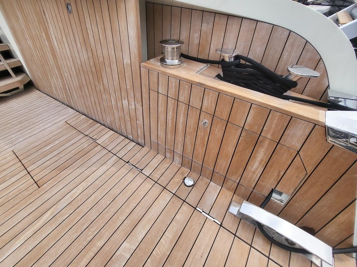 a black object on a wooden surface aboard EVO V8  Yacht for Sale