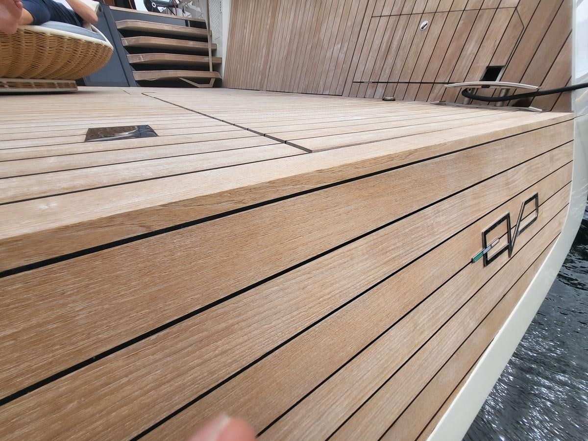 a wooden table with a metal frame aboard EVO V8  Yacht for Sale