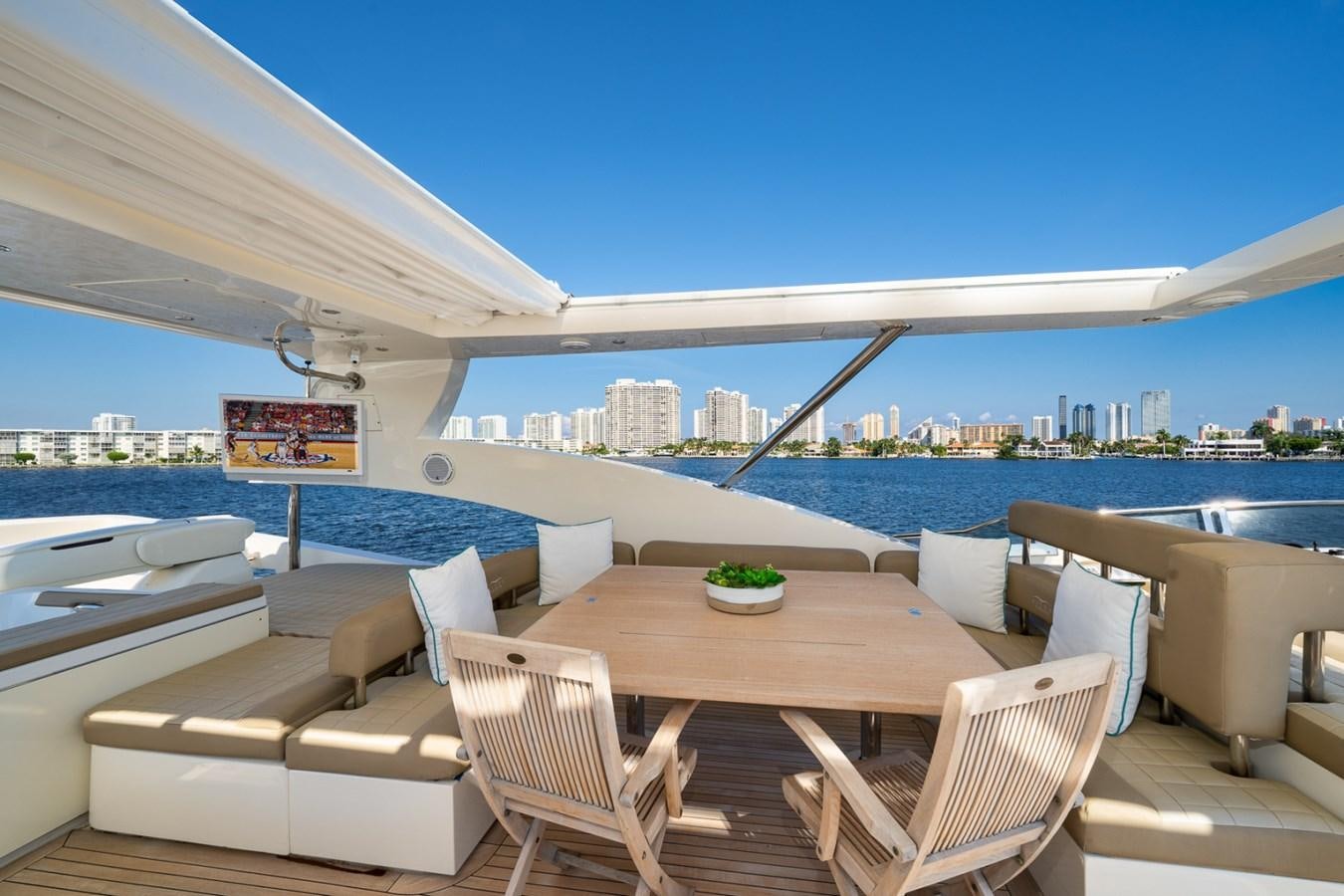 a table and chairs on a patio aboard KAERU Yacht for Sale