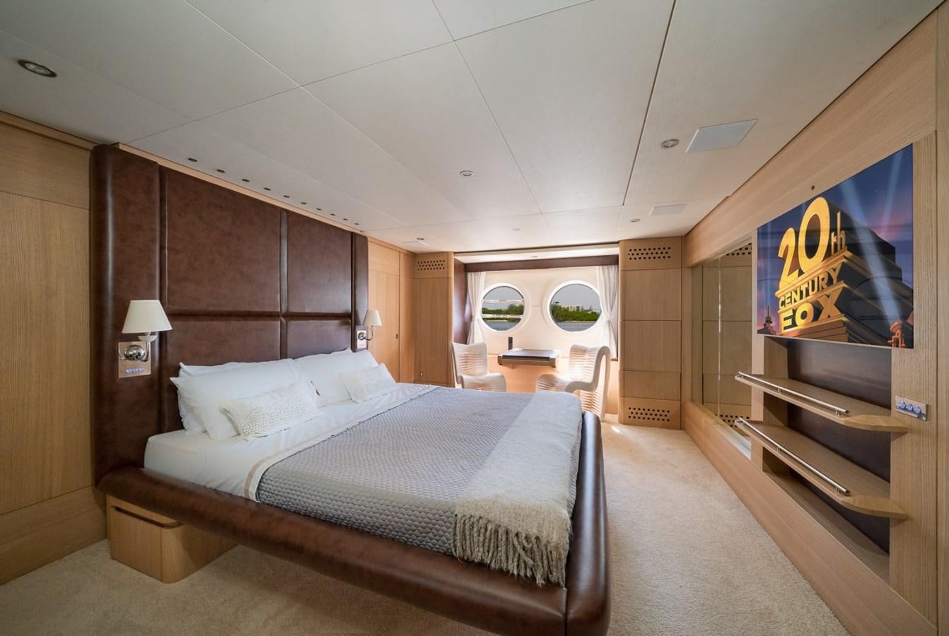 a bedroom with a bed and a desk aboard KAERU Yacht for Sale
