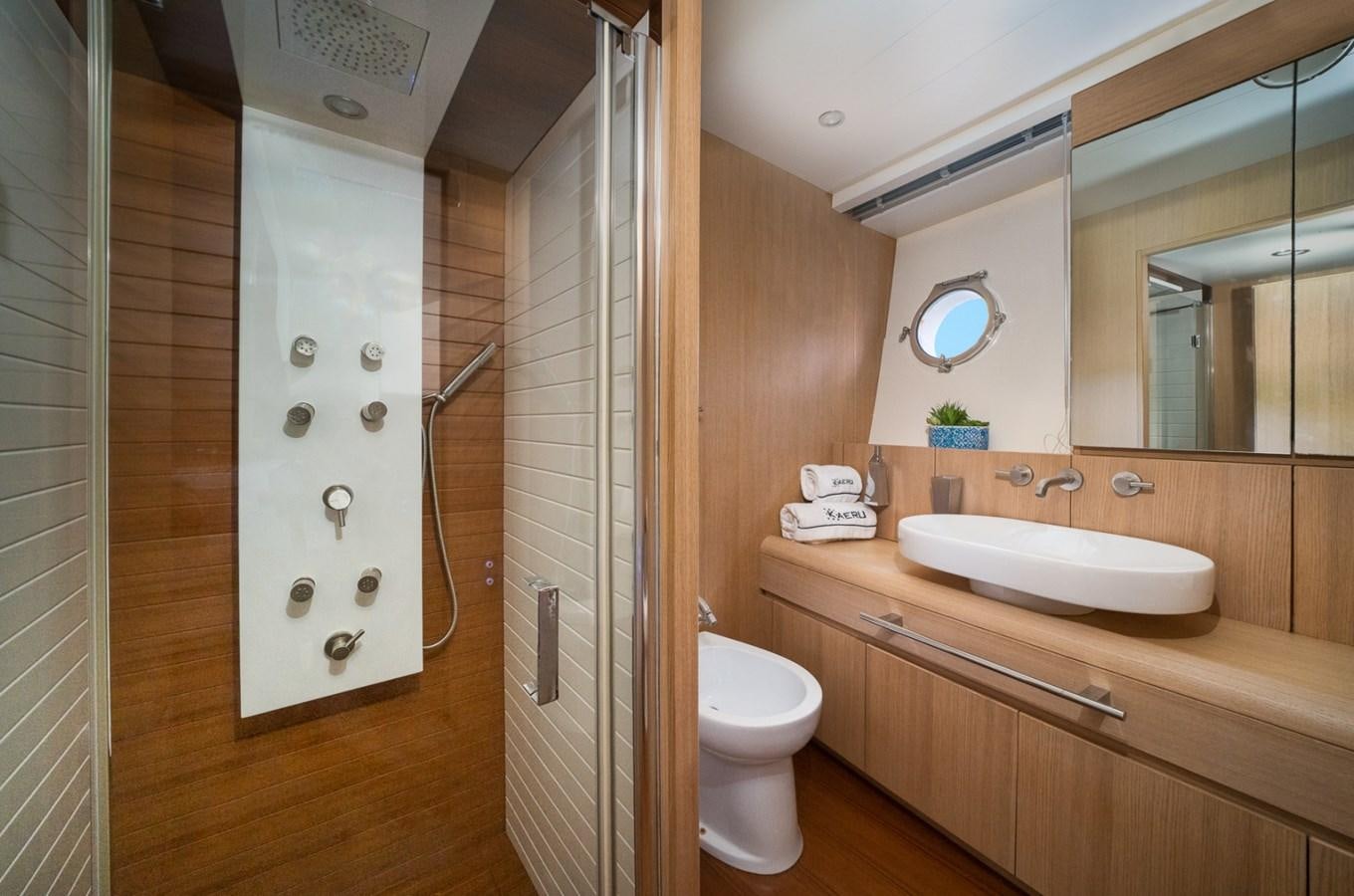 a bathroom with a glass shower aboard KAERU Yacht for Sale