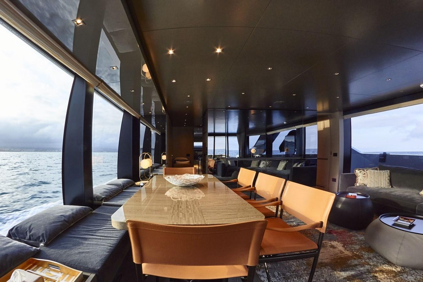a room with a table and chairs aboard SL96A Yacht for Sale