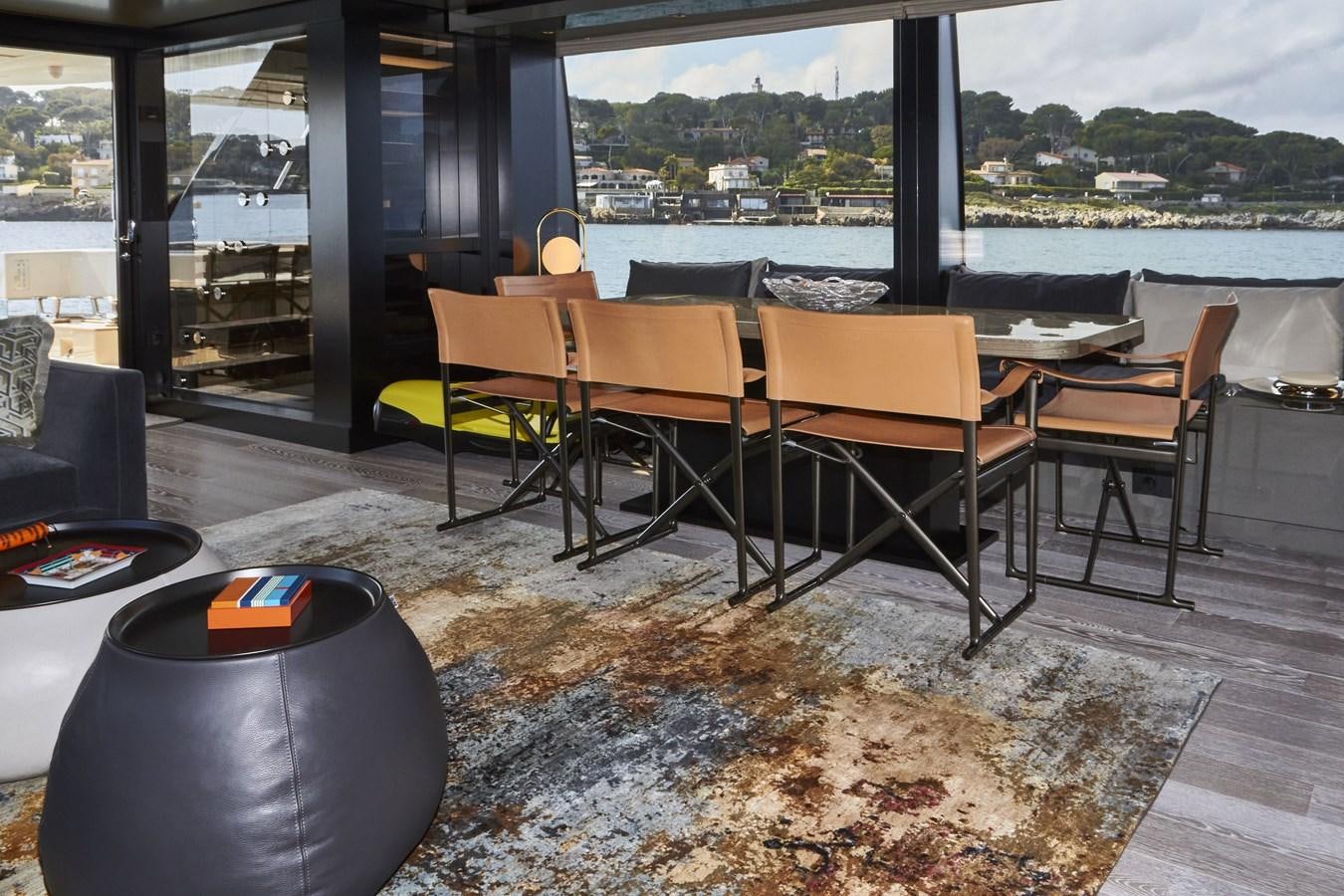 a room with a table and chairs aboard SL96A Yacht for Sale