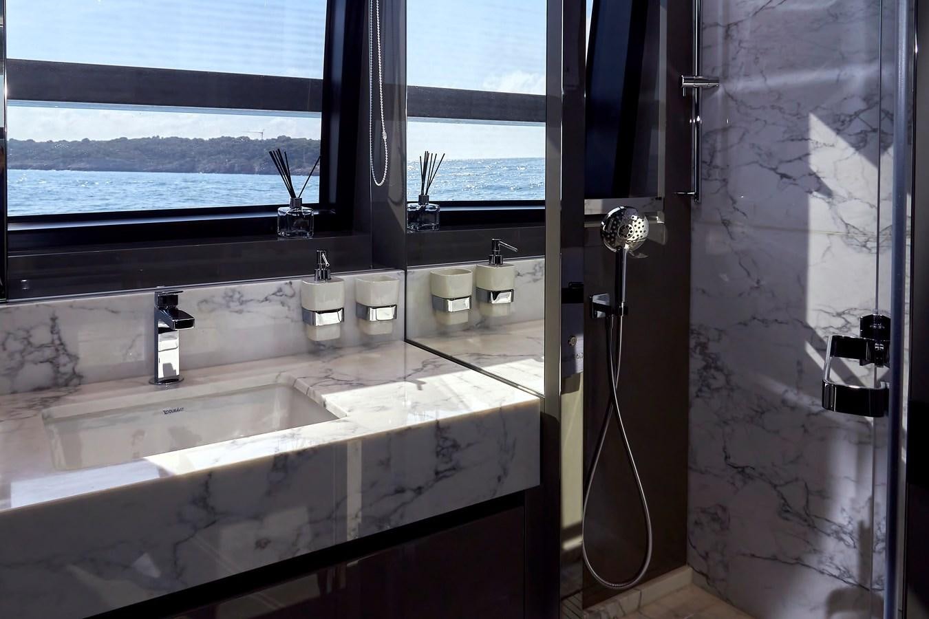a bathroom with sinks and a shower aboard SL96A Yacht for Sale