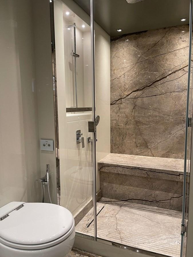 a bathroom with a glass shower aboard SL96A Yacht for Sale