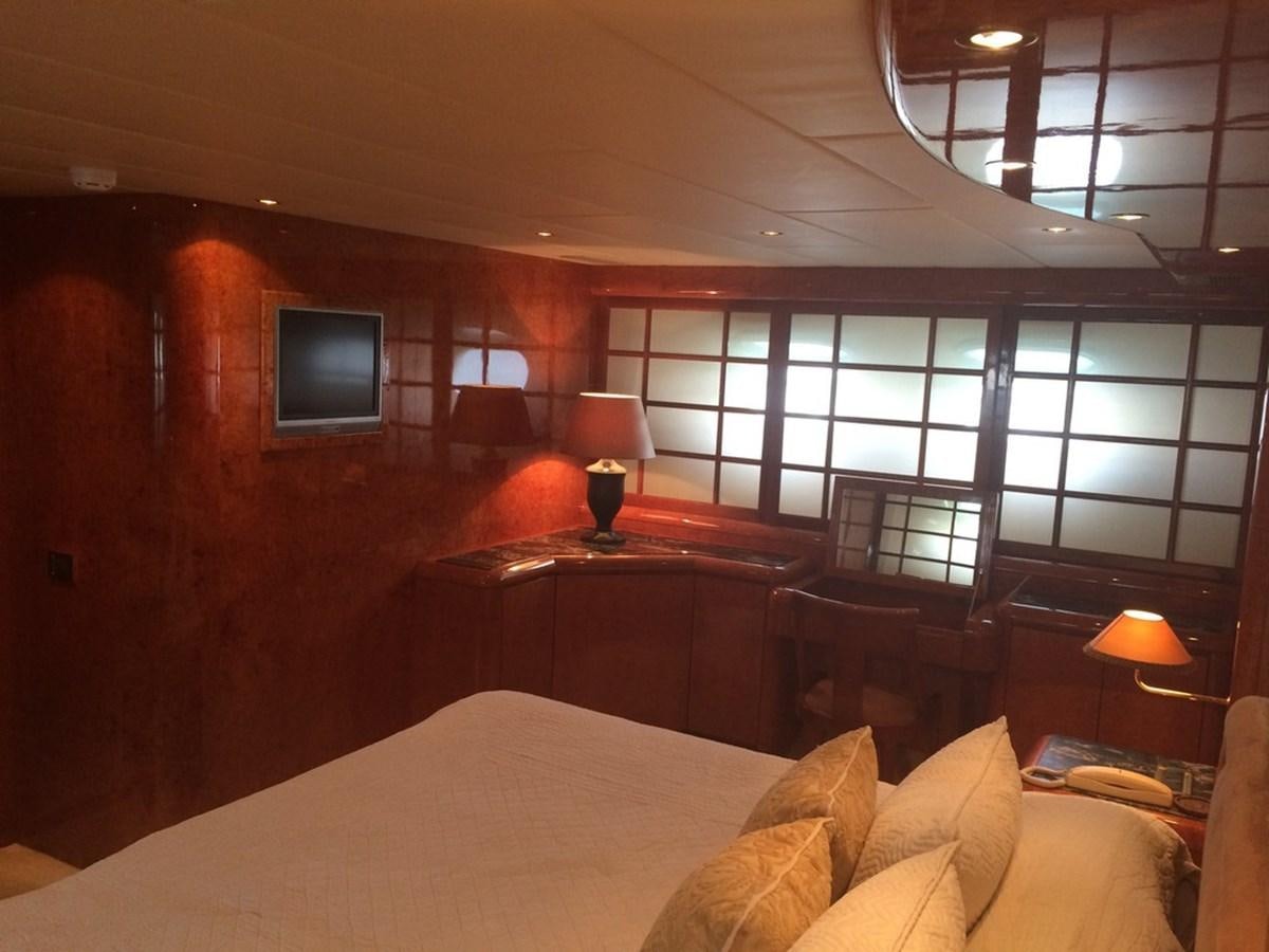 a room with a bed and a tv on the wall aboard BIRD OF PREY  Yacht for Sale