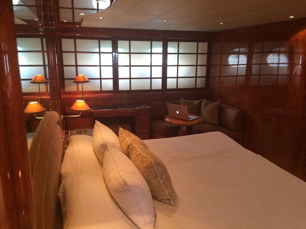 a room with a couch and a table with chairs aboard BIRD OF PREY  Yacht for Sale