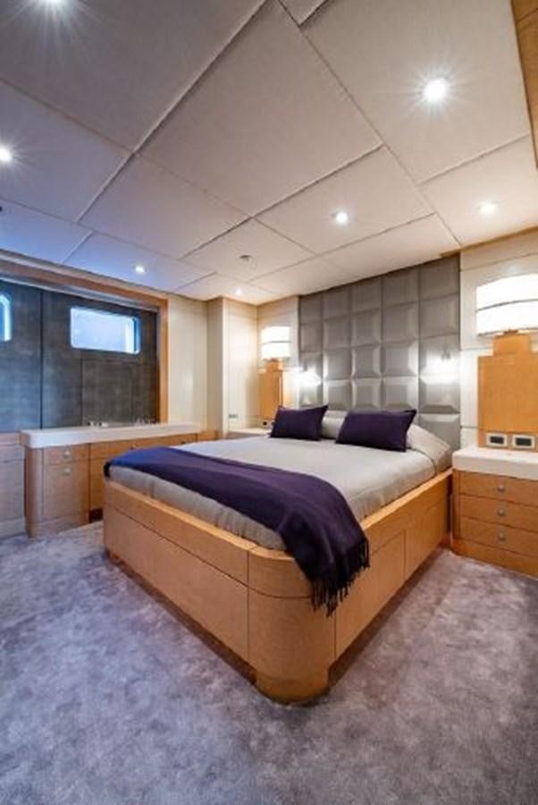 a bedroom with a bed and a desk aboard 174 OCEANFAST MOTOR YACHT Yacht for Sale