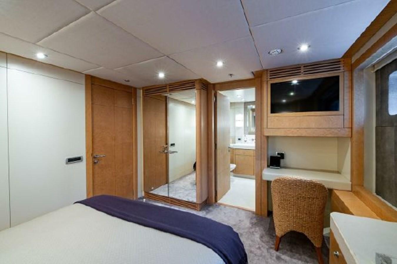 a bedroom with a bed and a closet aboard 174 OCEANFAST MOTOR YACHT Yacht for Sale