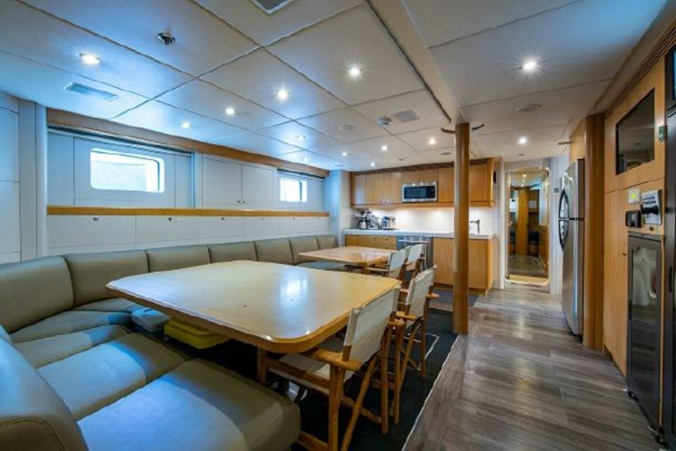 a room with tables and chairs aboard 174 OCEANFAST MOTOR YACHT Yacht for Sale