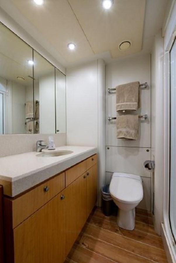 a bathroom with a sink toilet and a mirror aboard 174 OCEANFAST MOTOR YACHT Yacht for Sale