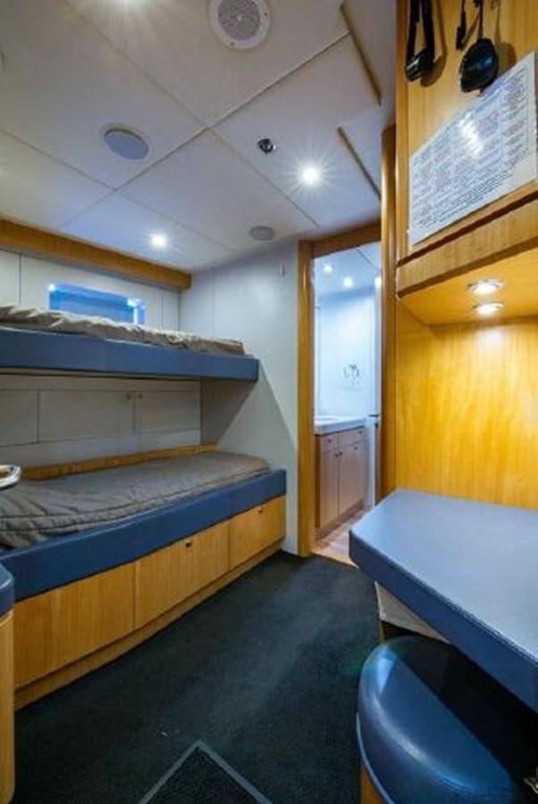 a room with a bed and a desk aboard 174 OCEANFAST MOTOR YACHT Yacht for Sale