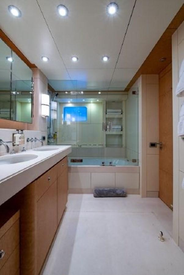 a bathroom with a tub sink and cabinets aboard 174 OCEANFAST MOTOR YACHT Yacht for Sale