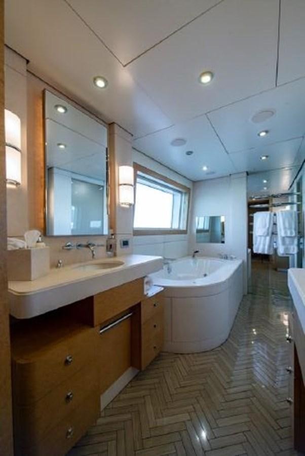 a bathroom with a tub sink and cabinets aboard 174 OCEANFAST MOTOR YACHT Yacht for Sale